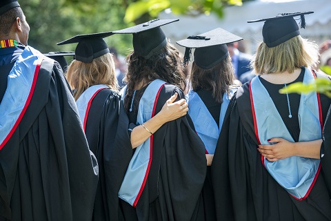 the backs of students in gowns